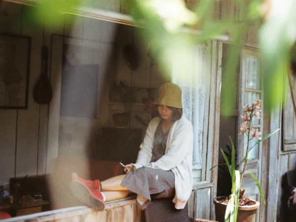 A girl smoking by her window