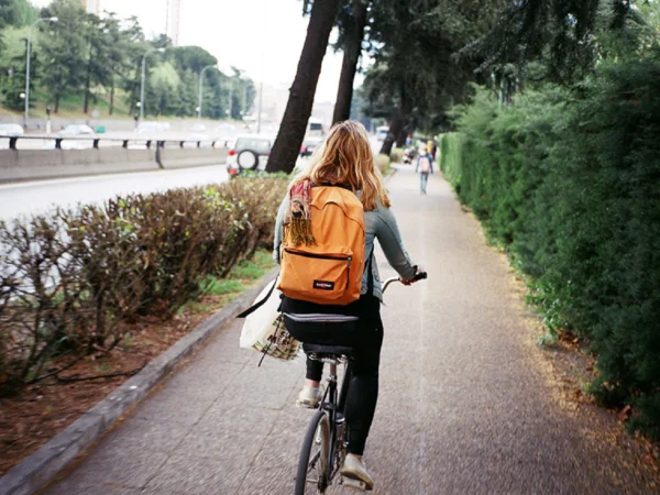 A woman riding her bike down the street