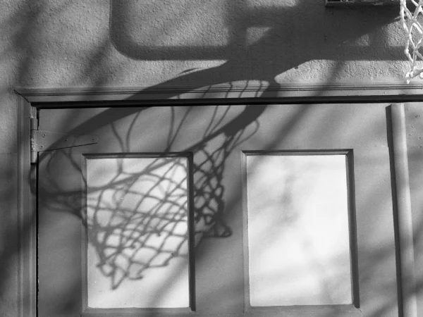 The shadow of a basketball net