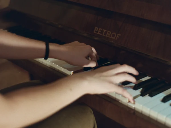 Close-up of hands playing the piano